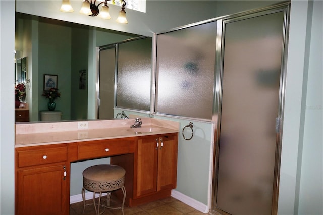 bathroom featuring tile patterned floors, vanity, toilet, and a shower with shower door