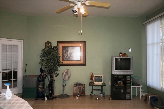 interior space with ceiling fan