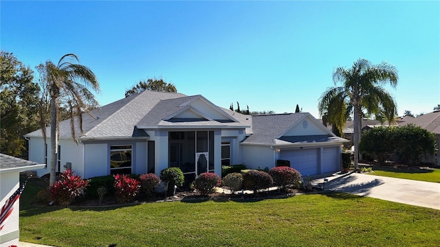 view of front of property featuring a front yard and a garage