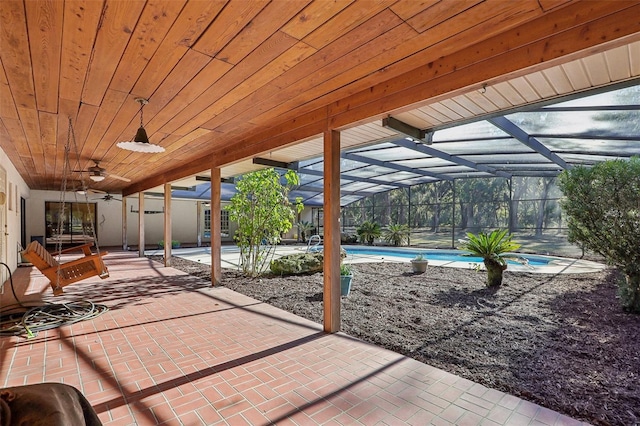 view of patio featuring glass enclosure and ceiling fan