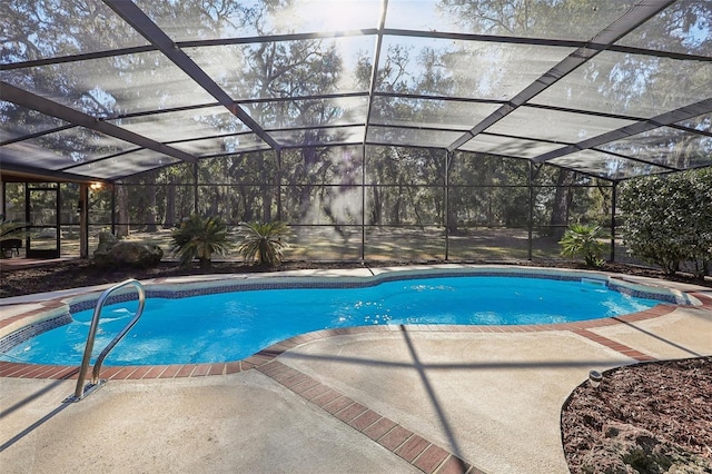 view of swimming pool with glass enclosure and a patio area