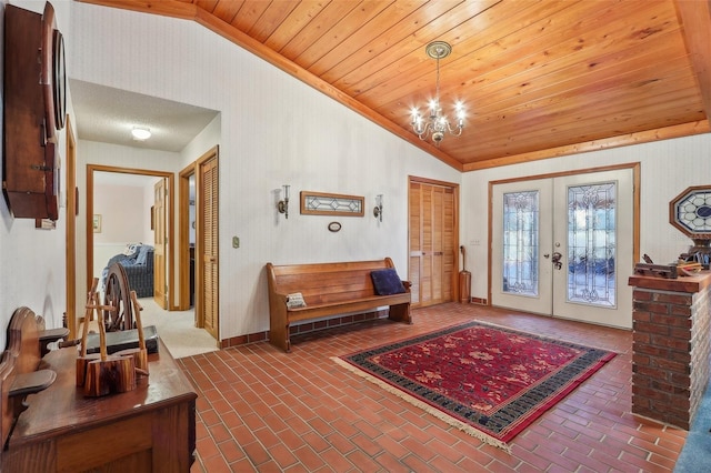 entrance foyer featuring a chandelier, french doors, wooden ceiling, and lofted ceiling