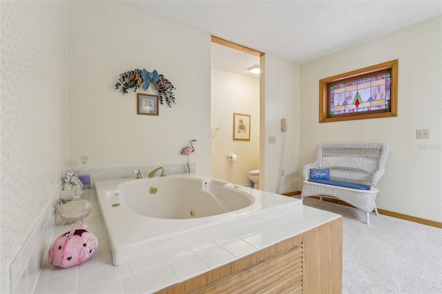 bathroom with a tub, a textured ceiling, and toilet