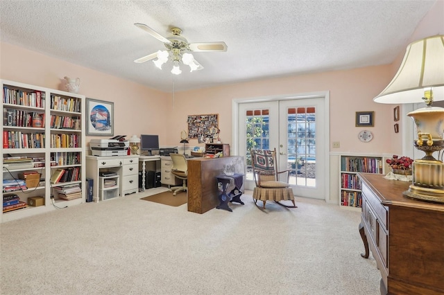 office area featuring carpet, french doors, a textured ceiling, and ceiling fan