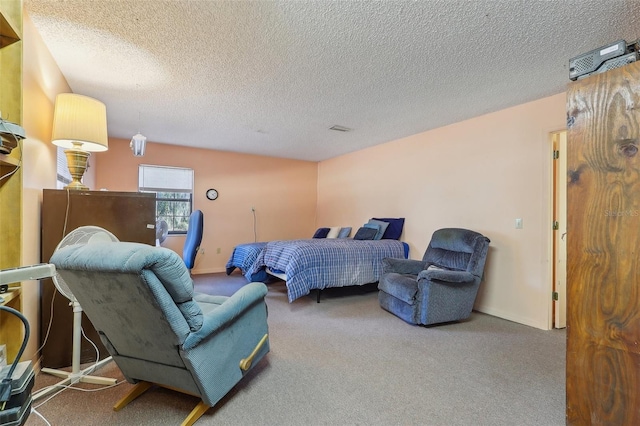 carpeted bedroom featuring a textured ceiling