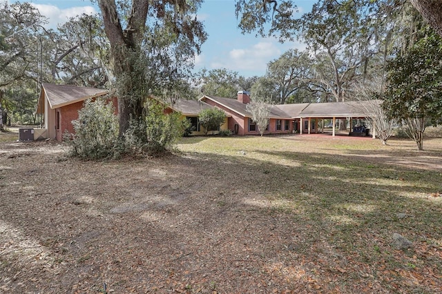 single story home featuring a front yard and central air condition unit