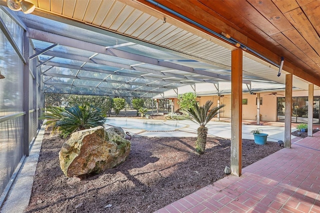 view of patio / terrace featuring glass enclosure