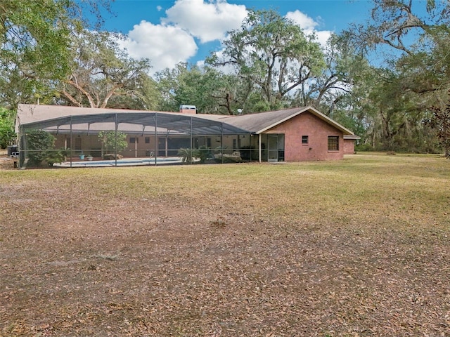 view of yard with a lanai and a swimming pool