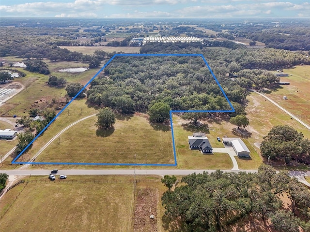 birds eye view of property with a rural view