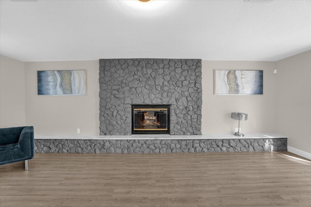 living room featuring a fireplace and light wood-type flooring