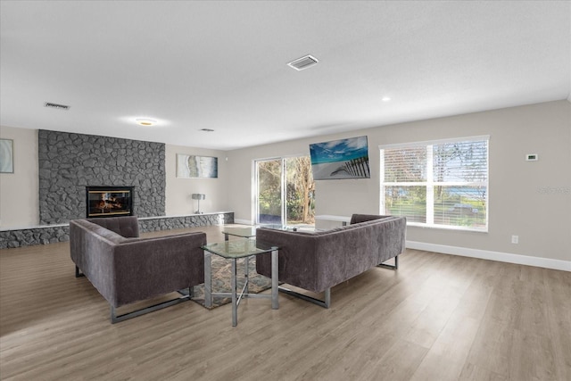 living room with a fireplace and light hardwood / wood-style flooring