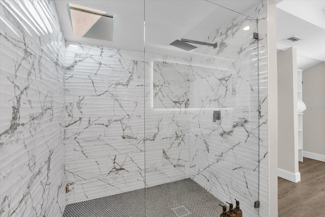 bathroom featuring a shower with door and hardwood / wood-style flooring