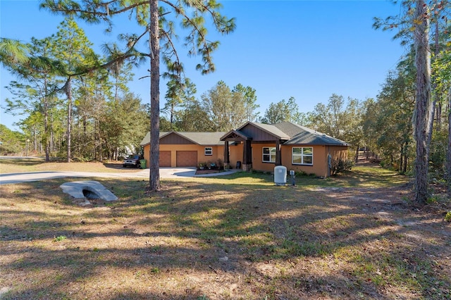 ranch-style house with a front yard and a garage