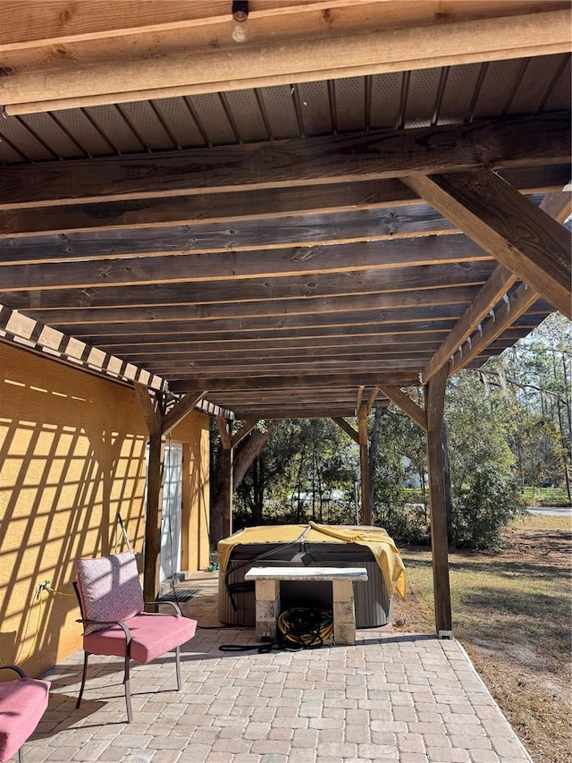 view of patio / terrace featuring a hot tub and a pergola