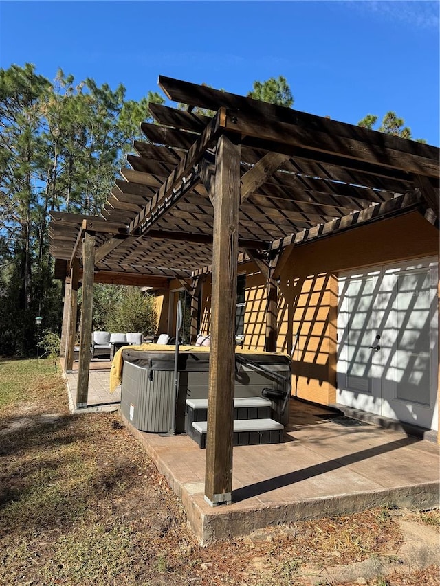 view of property's community with a hot tub, a pergola, outdoor lounge area, and a patio