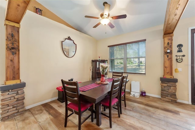 dining room with ceiling fan, lofted ceiling, and light hardwood / wood-style flooring