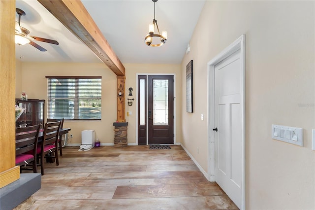 foyer entrance with hardwood / wood-style flooring, beam ceiling, and ceiling fan with notable chandelier