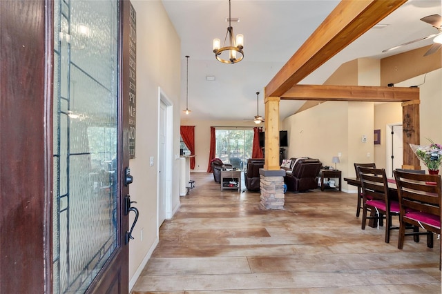 entryway with ceiling fan with notable chandelier, light wood-type flooring, and vaulted ceiling with beams