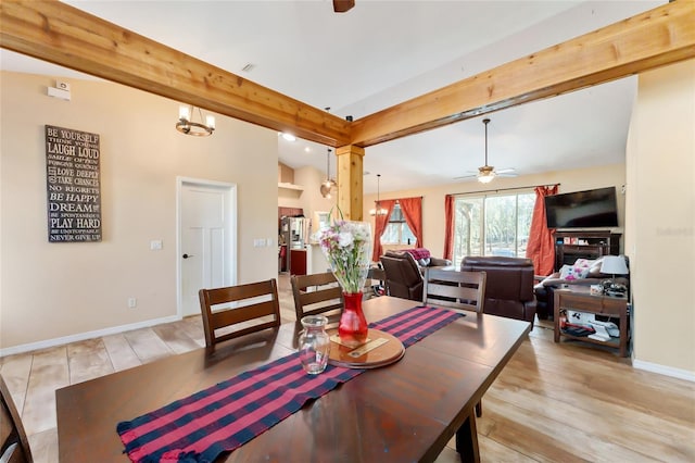 dining room featuring ceiling fan, vaulted ceiling with beams, and light hardwood / wood-style floors