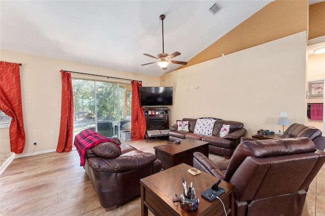 living room with ceiling fan, lofted ceiling, and light wood-type flooring