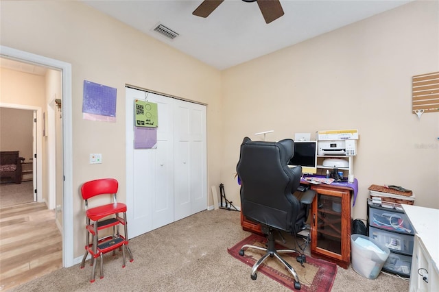 carpeted office featuring ceiling fan