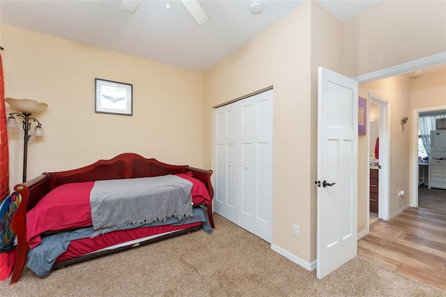 carpeted bedroom featuring ceiling fan and a closet