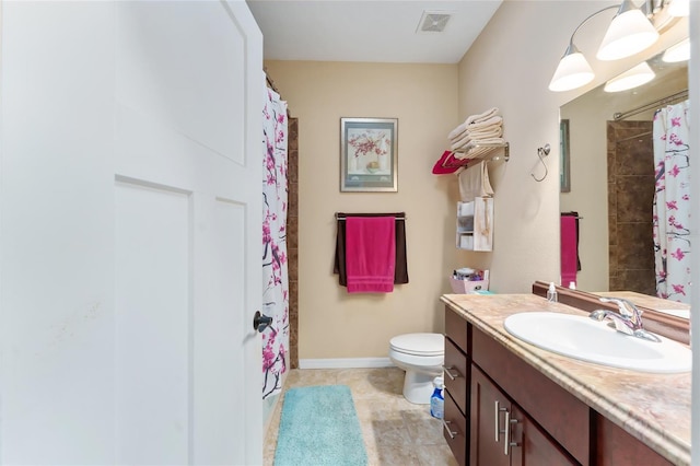 bathroom featuring curtained shower, toilet, and vanity