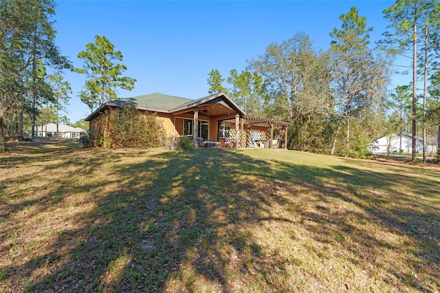 view of front of property featuring a front yard and a pergola