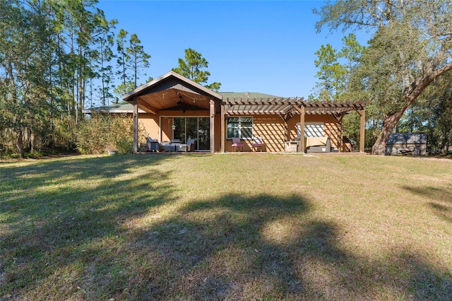 rear view of house featuring a yard and a pergola