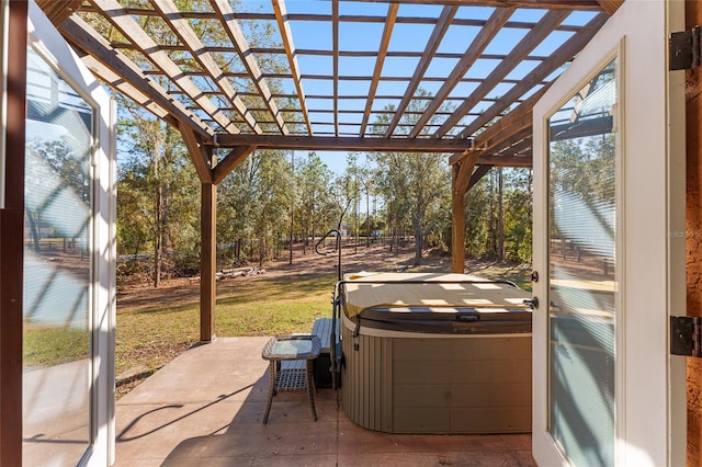 view of patio / terrace with a pergola and a hot tub