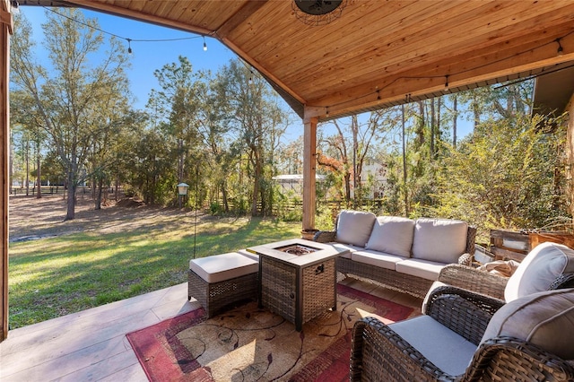 view of patio / terrace with an outdoor living space with a fire pit