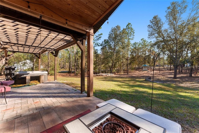 view of patio with a hot tub, a fire pit, and a pergola