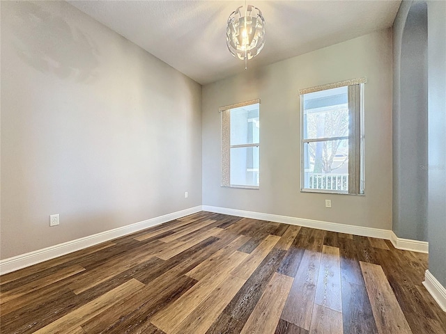 spare room featuring dark wood-type flooring