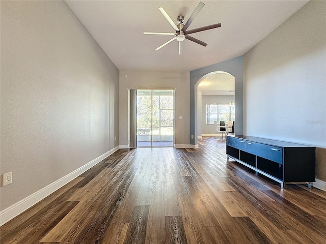 empty room featuring dark wood-type flooring and ceiling fan