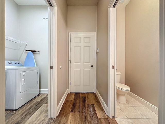 laundry room featuring washer / clothes dryer and light hardwood / wood-style floors