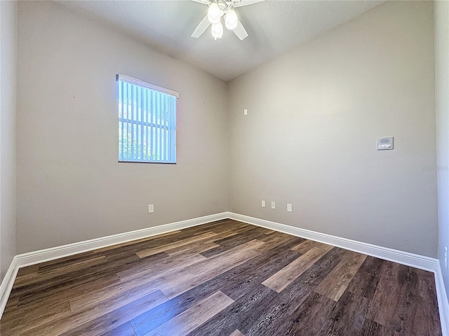 empty room featuring ceiling fan and dark hardwood / wood-style floors