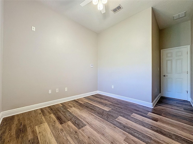 spare room with ceiling fan and dark hardwood / wood-style floors