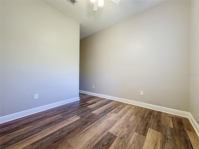 unfurnished room with a textured ceiling, ceiling fan, and dark hardwood / wood-style floors