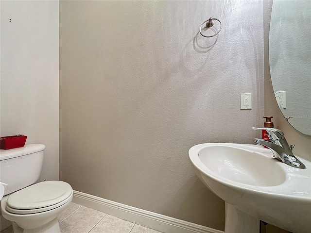 bathroom with sink, tile patterned flooring, and toilet