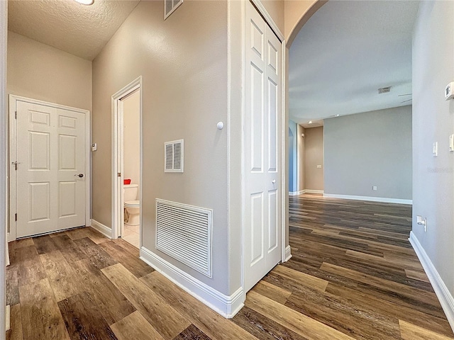 corridor with hardwood / wood-style flooring