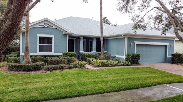 ranch-style house featuring a garage and a front lawn