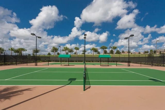 view of tennis court with basketball hoop