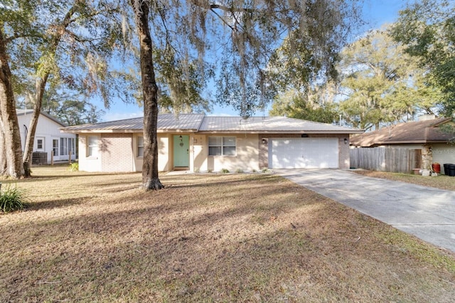 ranch-style house featuring a front lawn and a garage