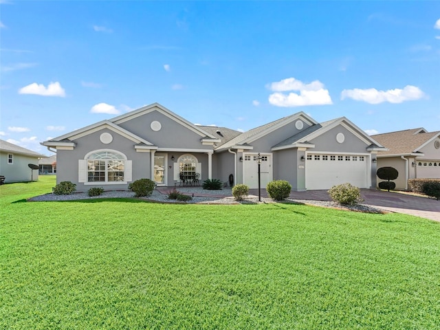 single story home featuring a garage and a front lawn