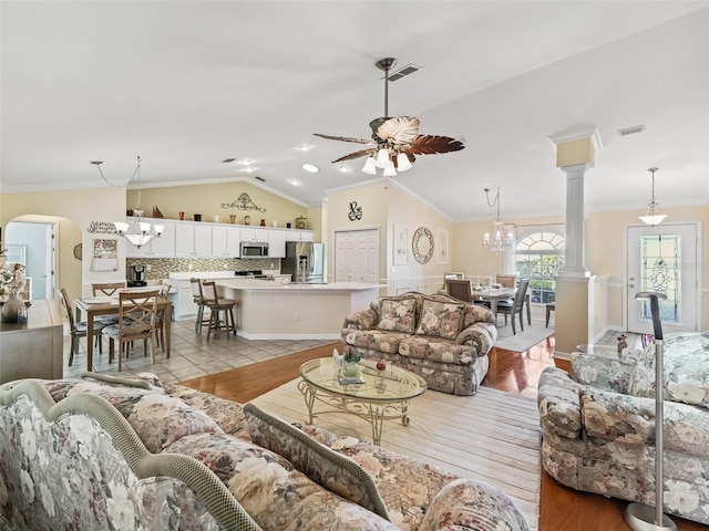 living room with light hardwood / wood-style floors, vaulted ceiling, and ornamental molding