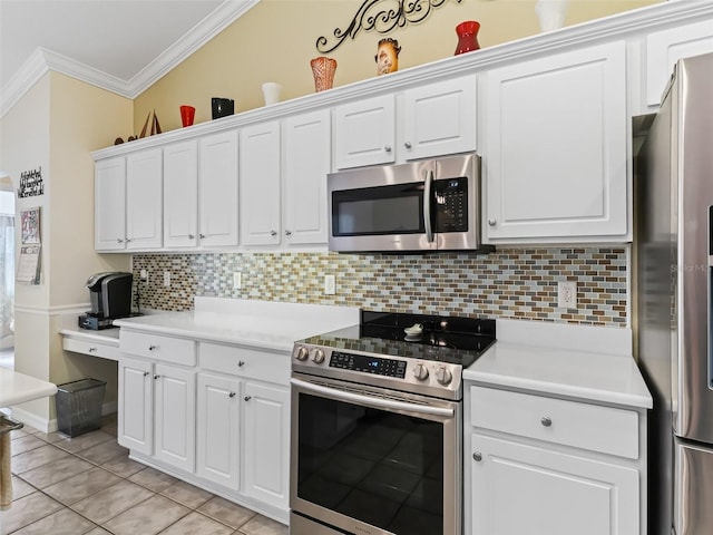 kitchen featuring white cabinets, stainless steel appliances, decorative backsplash, light tile patterned floors, and crown molding