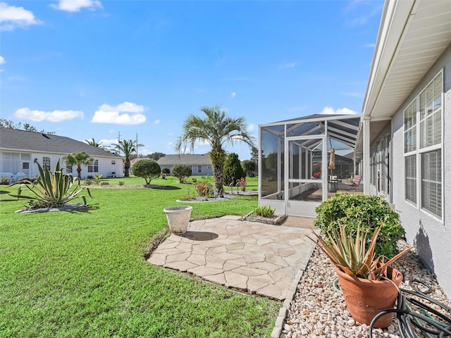 view of yard featuring a patio and a lanai