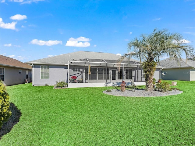 rear view of property featuring glass enclosure and a yard