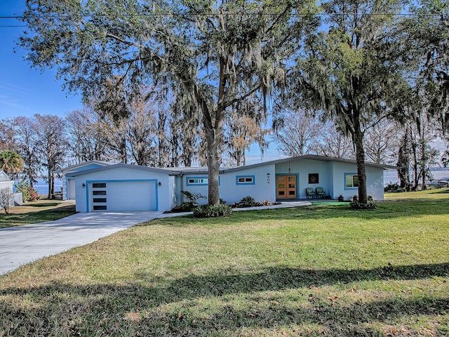 single story home featuring a garage and a front yard