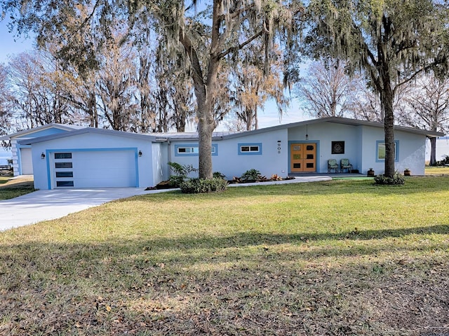 single story home with a garage, a front yard, and french doors